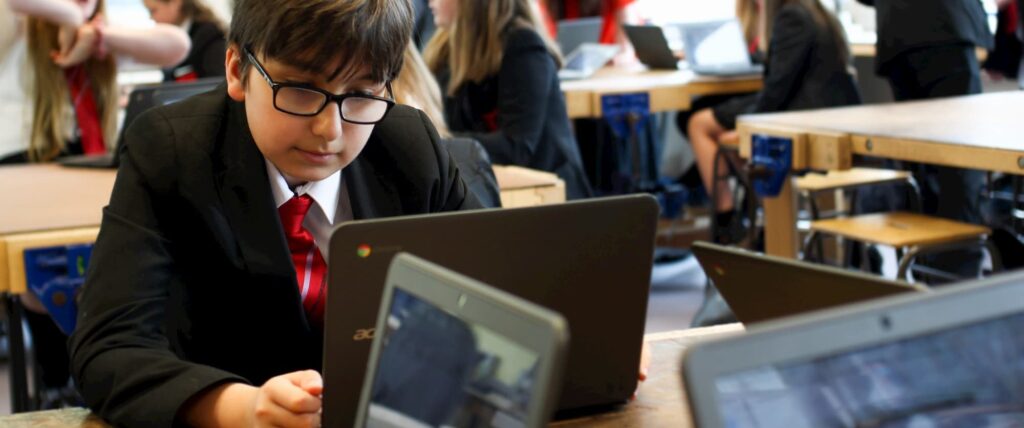 students using laptops to do work