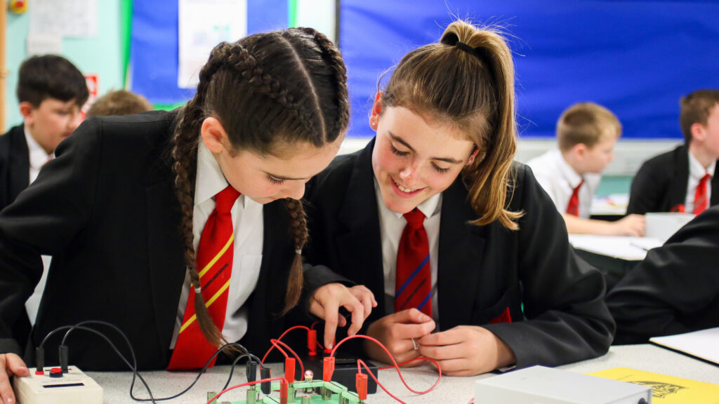 students in a classroom doing a science experiment
