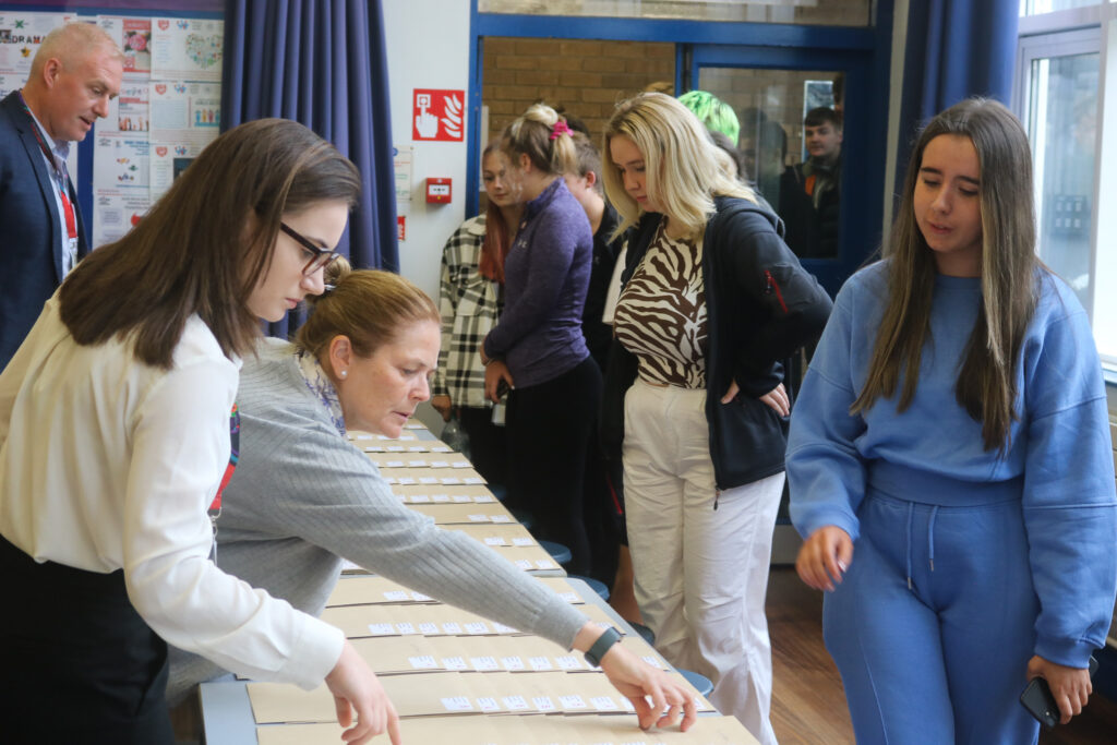 Students collecting exam results for their GCSEs