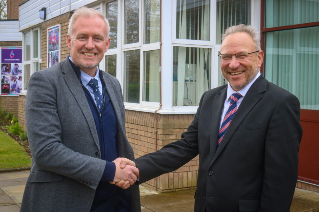 new headteacher of south Wirral school shaking hands with former headteacher